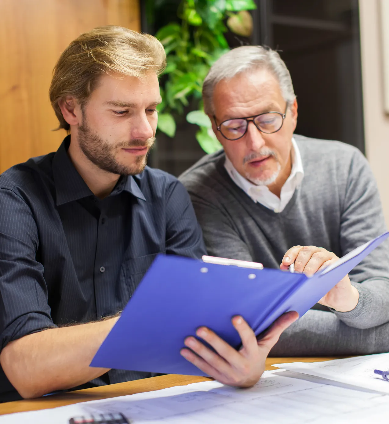 Two professionals reviewing documents